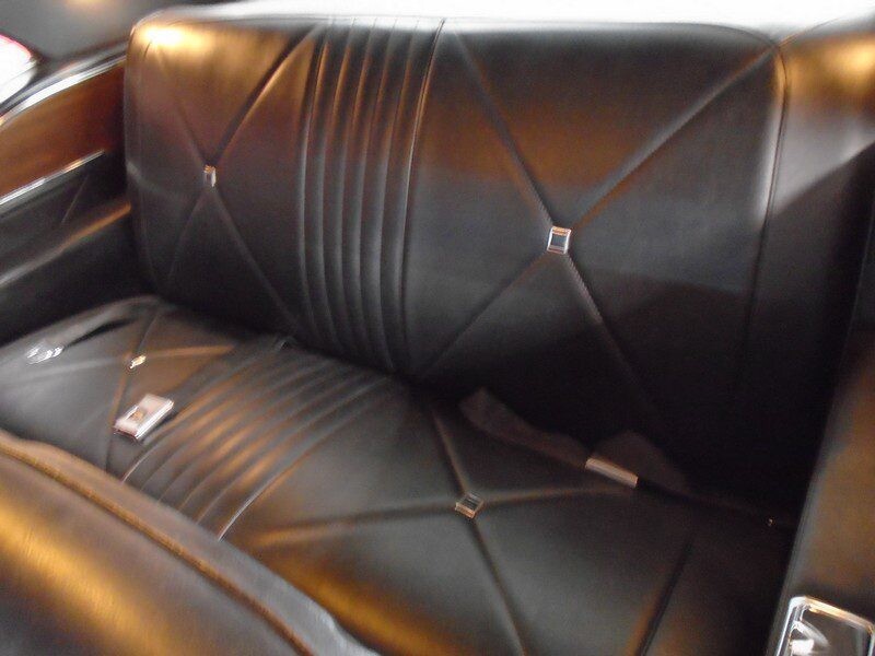 Classic car's black leather backseat.