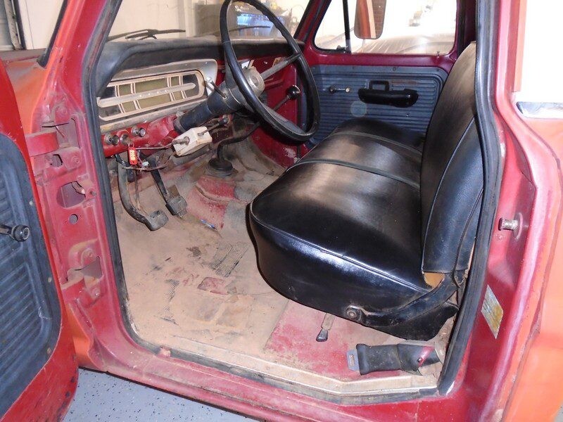 Red Ford truck cab interior view.
