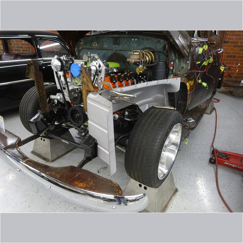 Classic car engine being installed.