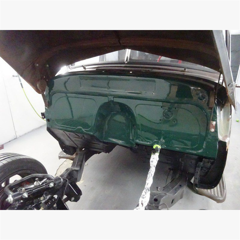 Dark green classic car body restoration.