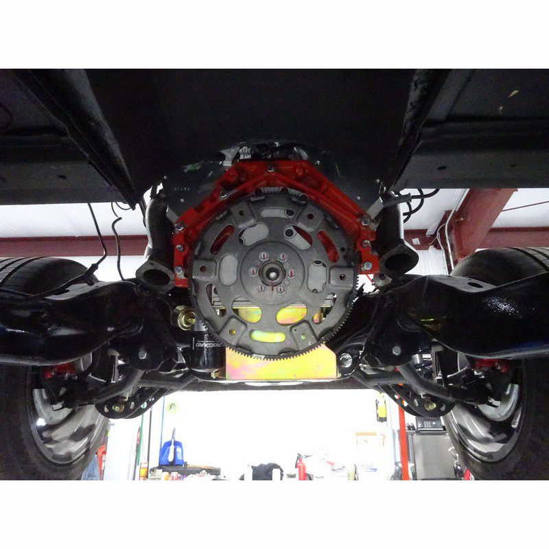 Underside view of car engine and transmission.