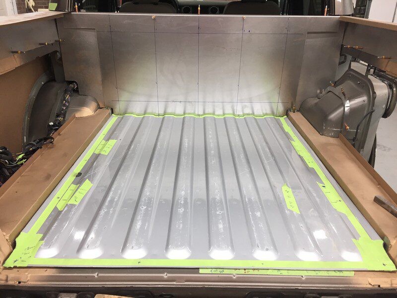 Truck bed metal installation in progress.