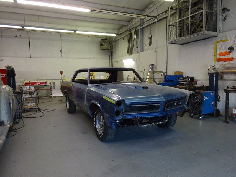 Blue GTO in auto body shop.