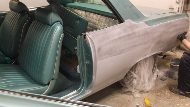 Classic car undergoing bodywork restoration.