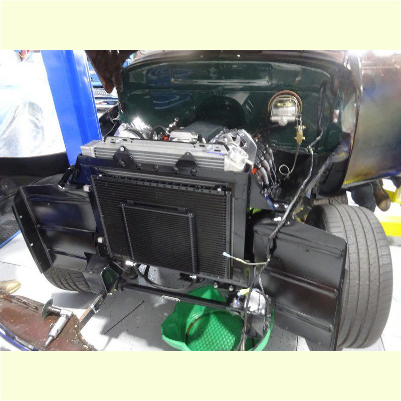 Classic car engine bay radiator installation.