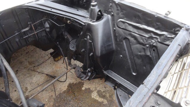 Black painted car engine bay.