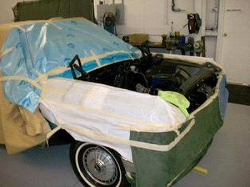 Car covered in protective paint masking.
