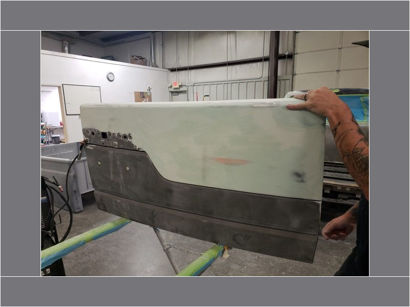 Truck tailgate body repair in progress.