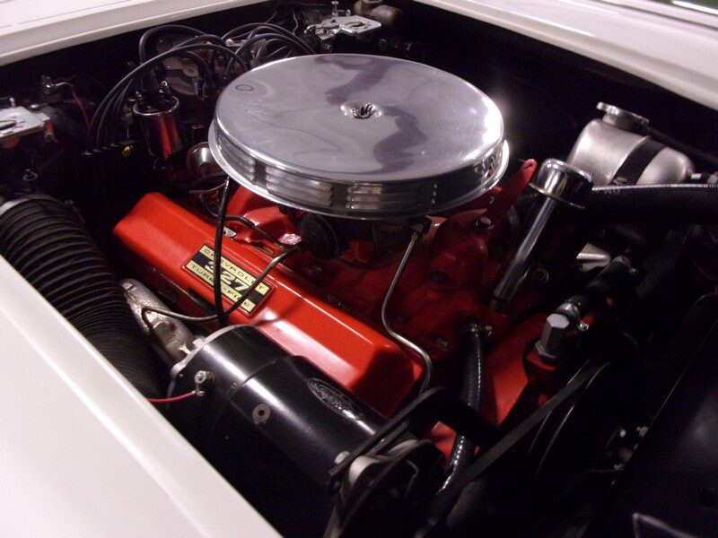 Classic car engine, red valve covers.