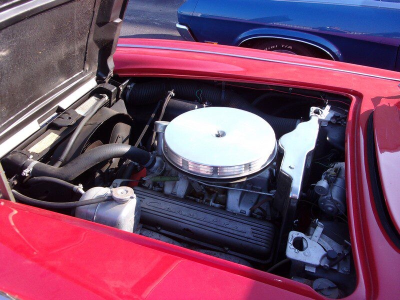 Red classic car engine close-up.