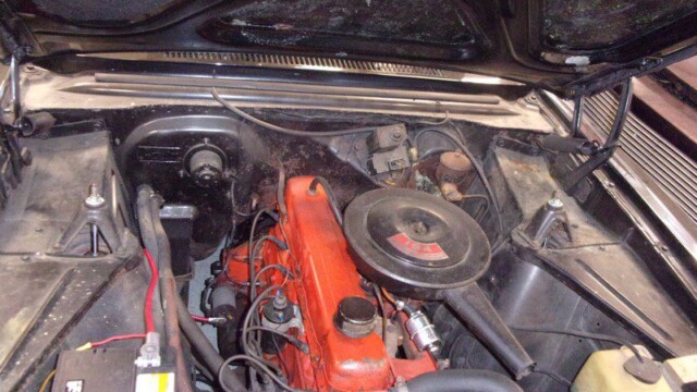 Aged engine bay with orange valve cover
