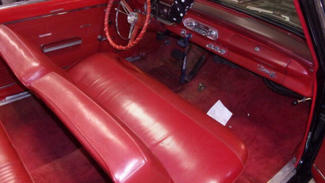 Red interior of a classic Chevy Nova convertible.