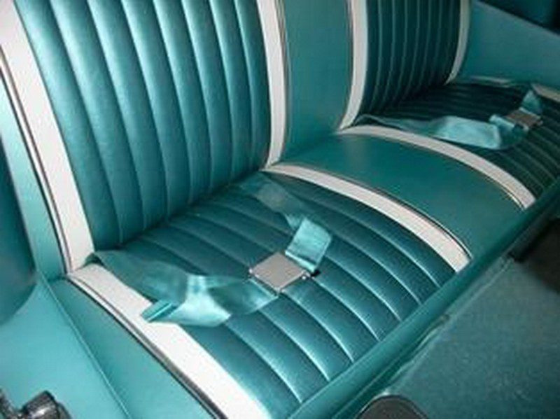 Teal car seat with white stripes.