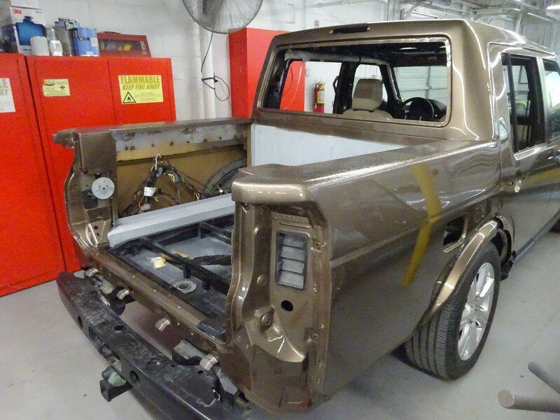 Brown Land Rover pickup truck body.