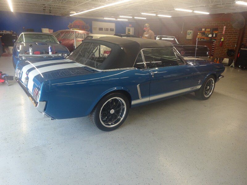 Side profile of blue convertible Mustang