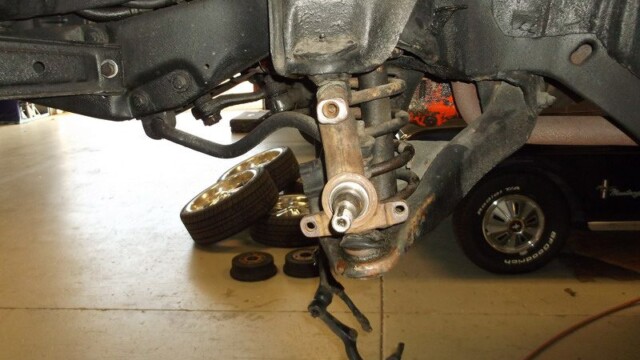 Car suspension component with removed brake drum.