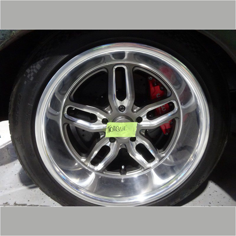 Custom aluminum car wheel with red brakes.