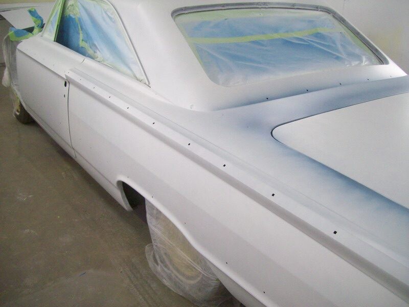 White classic car, rear quarter panel, paint job.