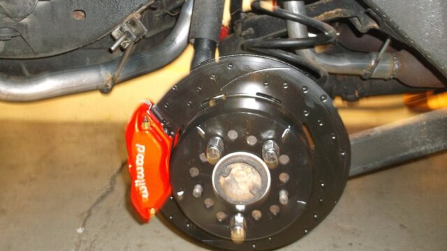 Red caliper and black disc brake.