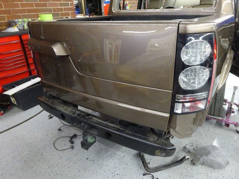 Brown Land Rover rear bumper damage.