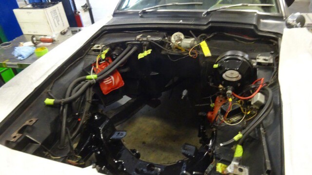 Car engine bay during restoration.