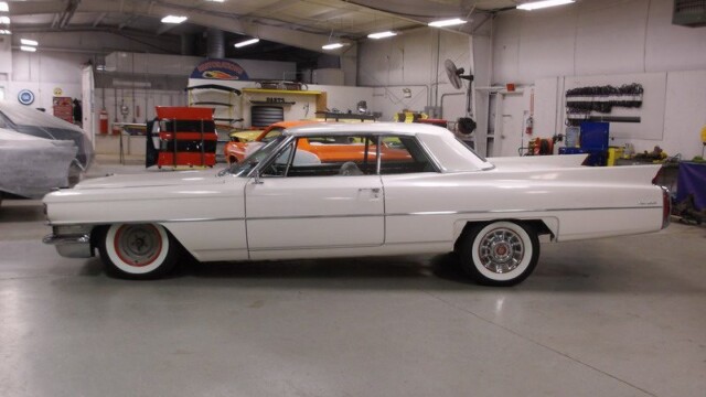 White classic Cadillac in auto shop.