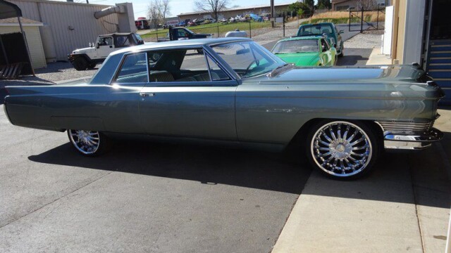 Gray classic Cadillac coupe, custom rims.