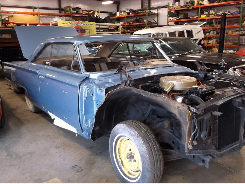 Blue classic car under restoration.