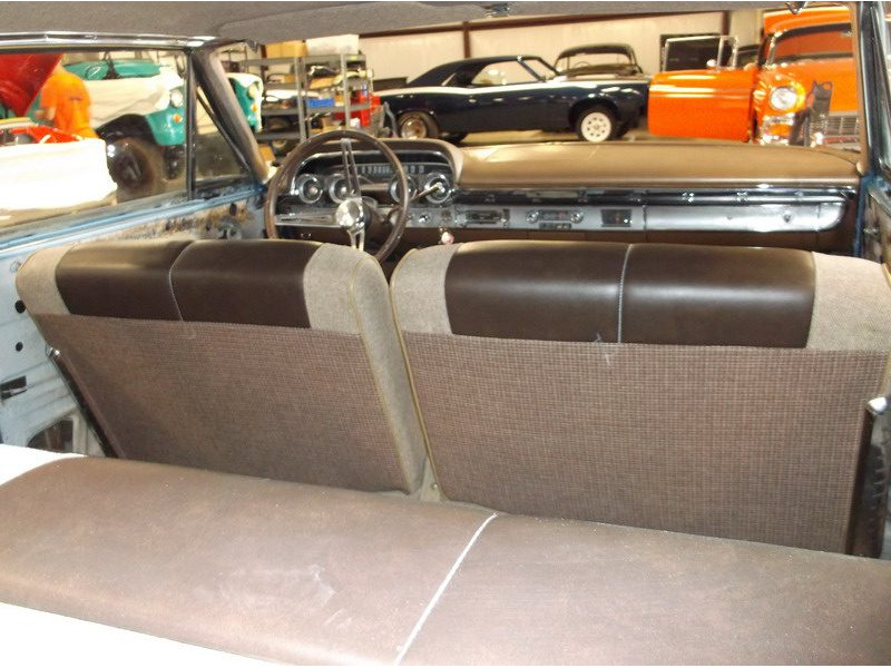 Classic car's brown interior back seats.