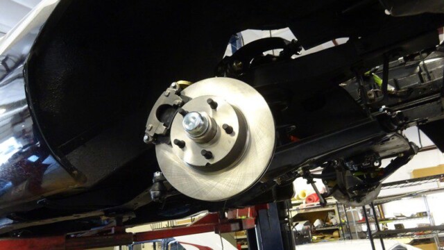 Car's disc brake rotor and caliper assembly.