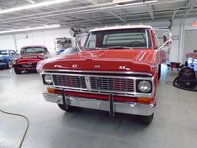 Red Ford truck in auto repair shop.