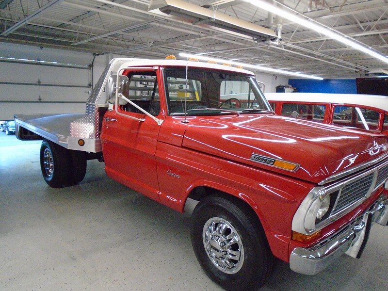 Red Ford F-250 flatbed truck.