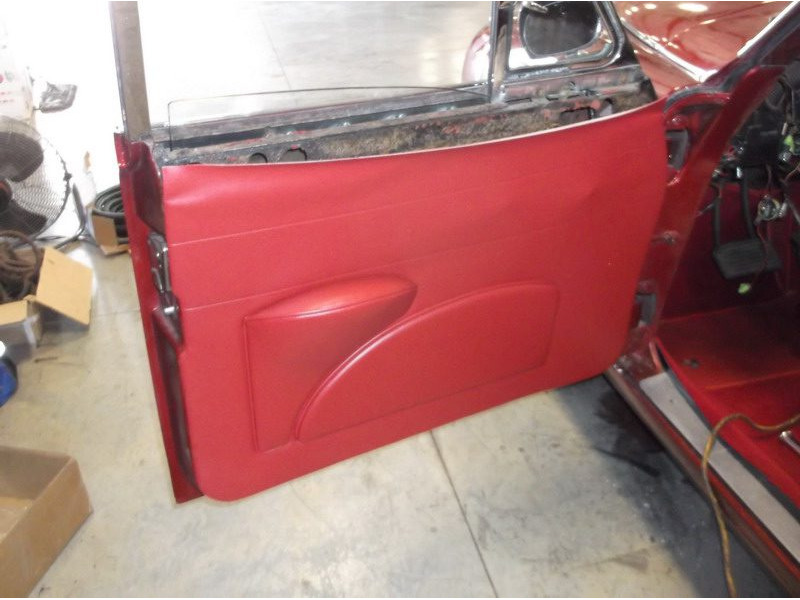Red car door panel installation.