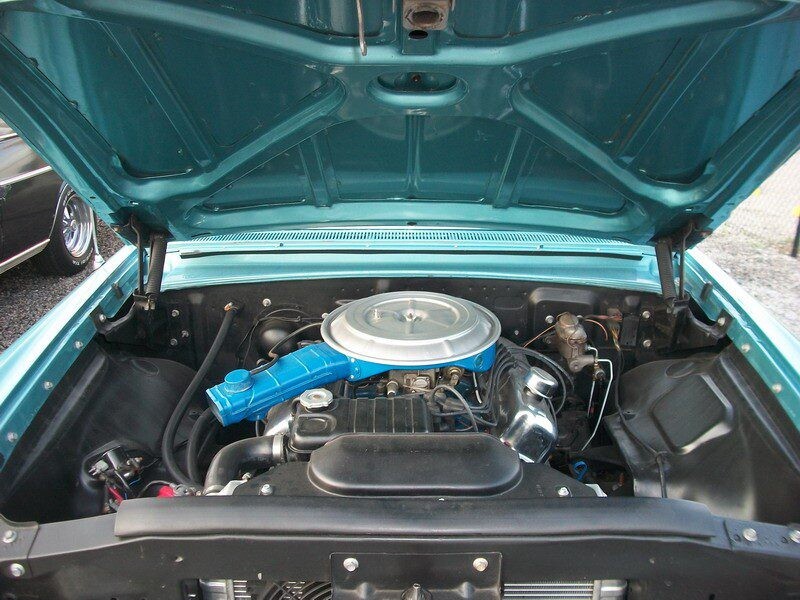 Turquoise hood reveals vintage engine bay