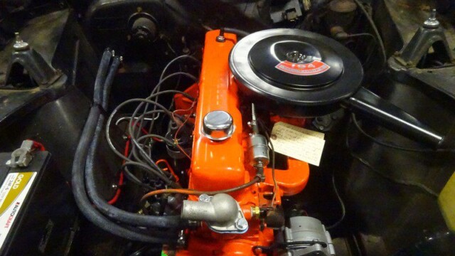 Orange Chevy small-block engine bay.
