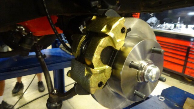 Gold brake caliper and disc rotor assembly.