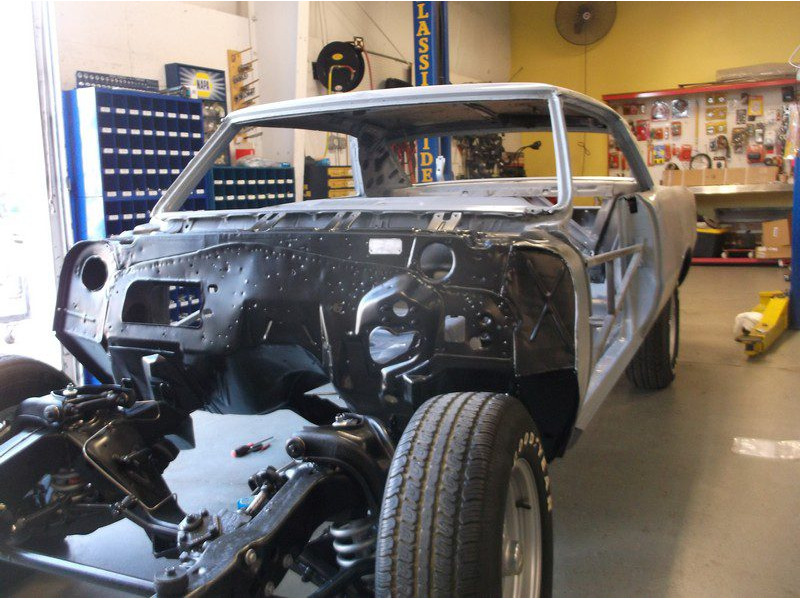 Classic car body undergoing restoration.