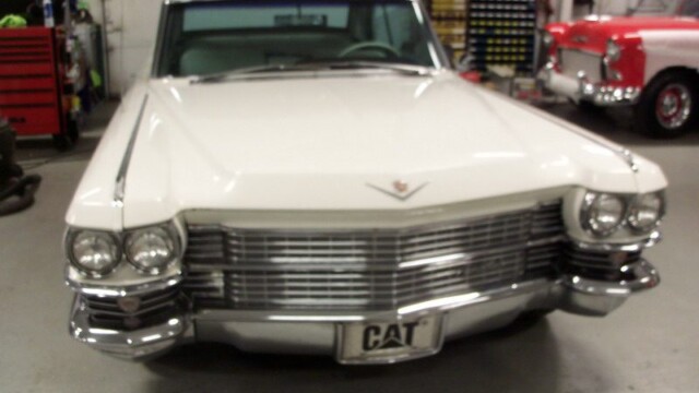 White Cadillac classic car, front view.