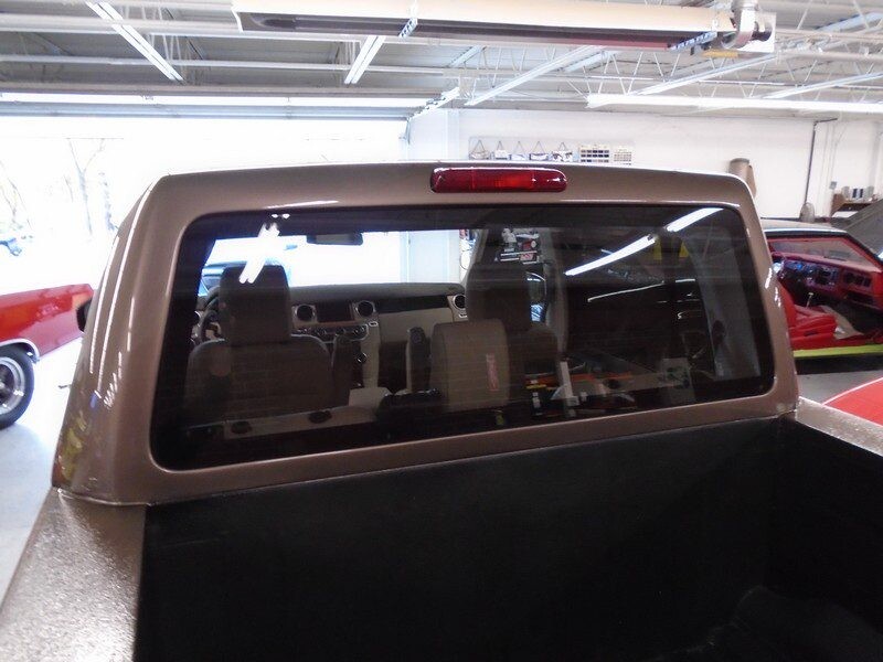 Brown truck bed with rear window.