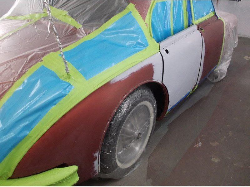 Classic car in auto body shop, repainted.