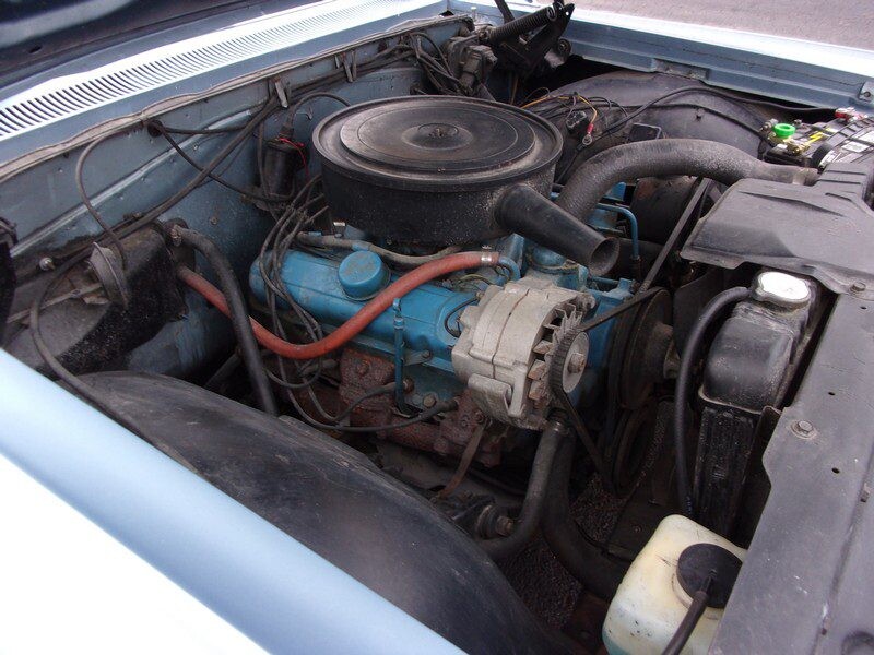 Worn blue engine block with red coolant hoses
