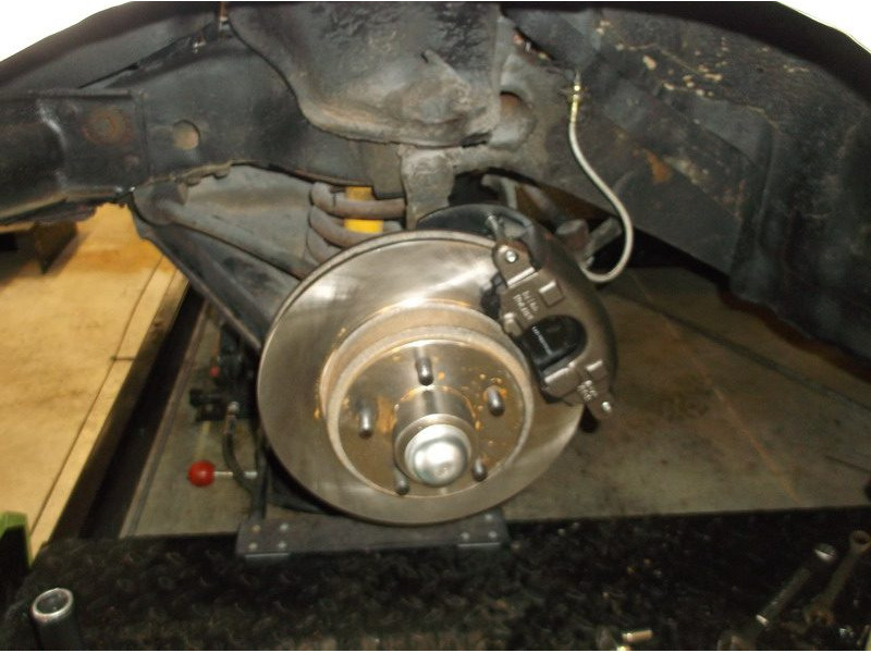 Car brake rotor and caliper assembly.