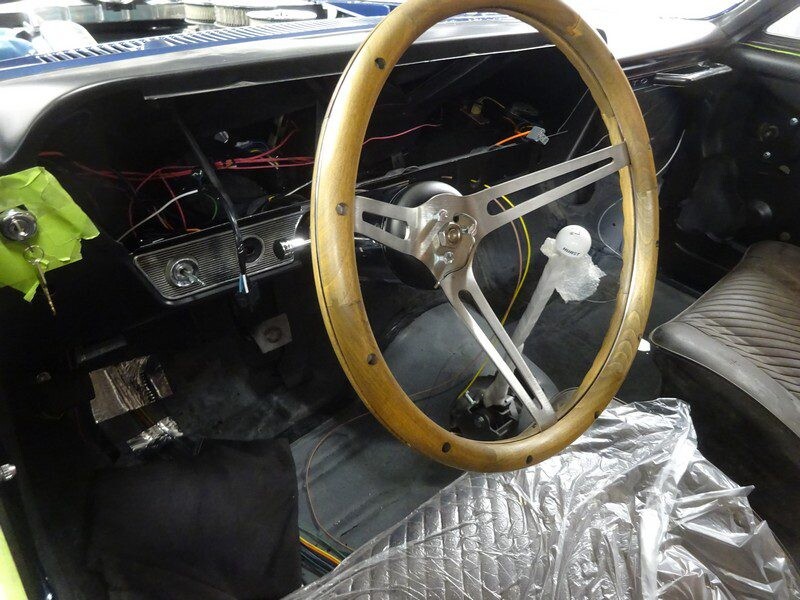 Classic car interior, wooden steering wheel.