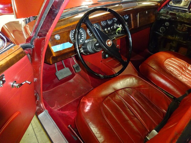 Red leather interior of classic Jaguar.