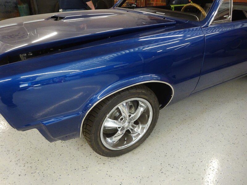 Blue classic car in a garage.