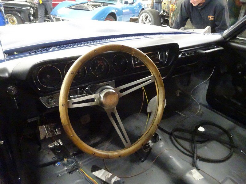 Classic car's wooden steering wheel interior.