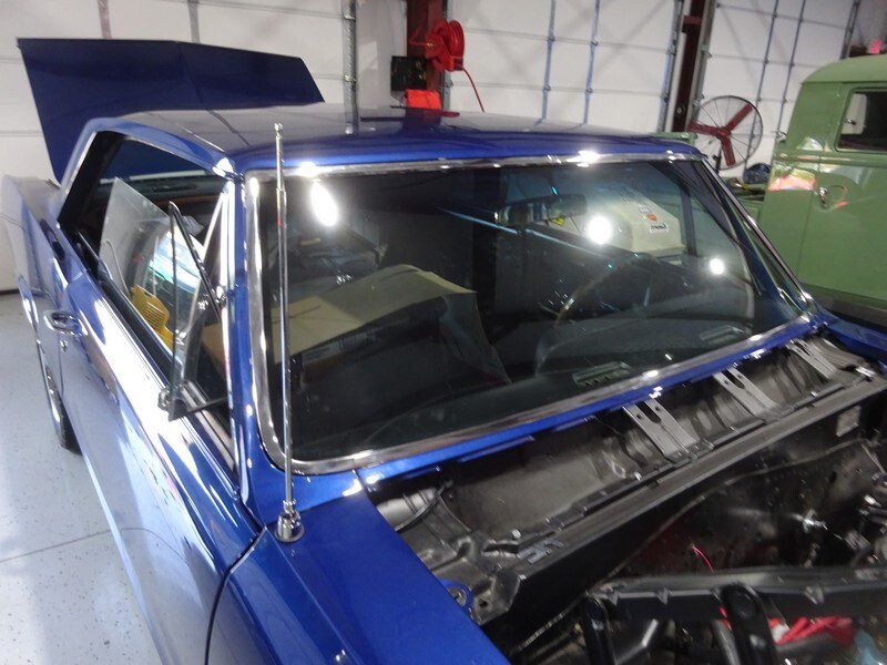 Blue classic car under repair.