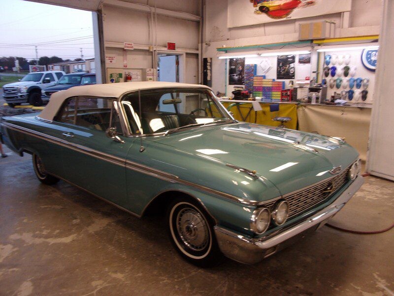 Restored teal Ford Fairlane convertible.