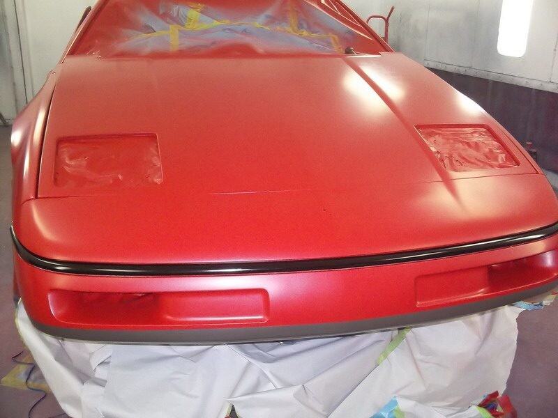Red sports car, freshly painted.