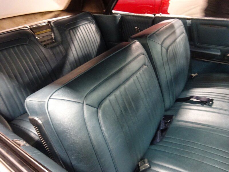 Classic car's teal leather back seats.